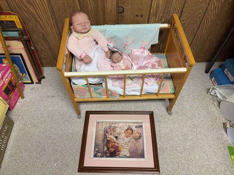 Doll crib with print and two Ashton-Drake rubber dolls image