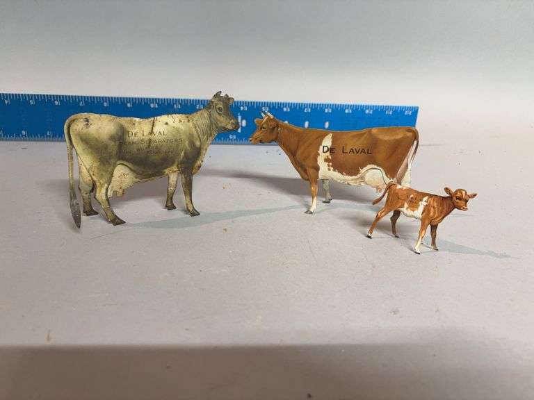 Two DeLaval tin advertising cows, one calf image
