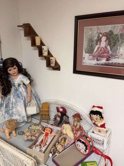 On desk and wall includes step shelf, doll picture, Betty Boop items and dolls image