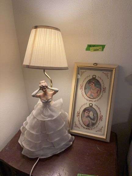 Approx 24” tall porcelain lady table lamp and framed ladies Appears the arm of the lamp has been repaired Holds 2 bulbs so lower half lights up her dress image