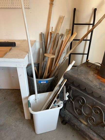 Galvanized trash can, full of miscellaneous handles, metal curtain rods etc