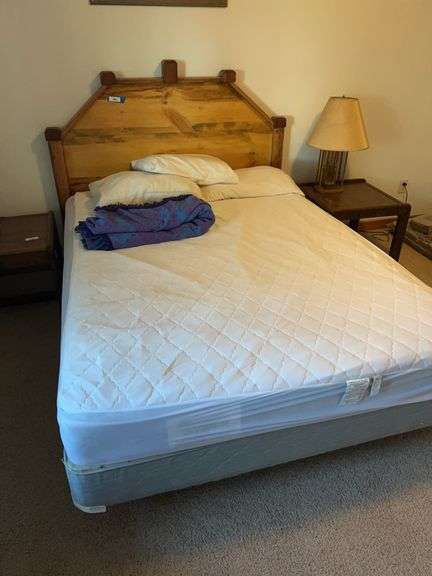 Full-size queen bed with wood headboard