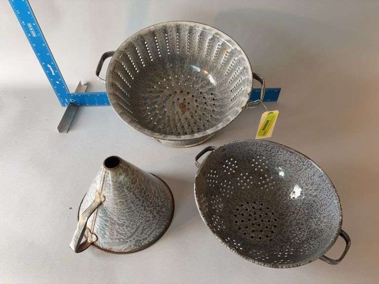 Two granite ware strainers and a funnel image