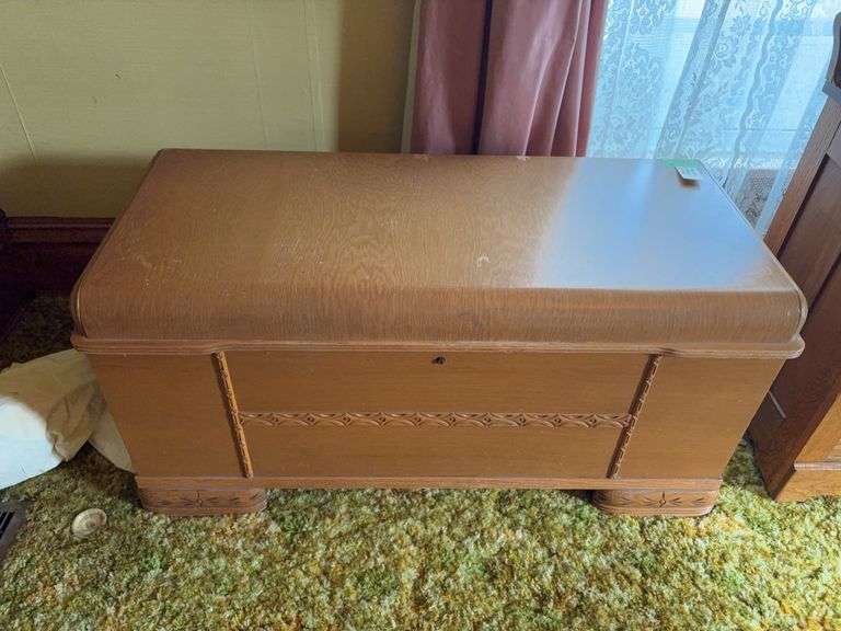 Unmarked cedar chest with blonde oak veneer with waterfall front, carved legs and front 18D x 45L x 22H Does have some veneer damage to top image