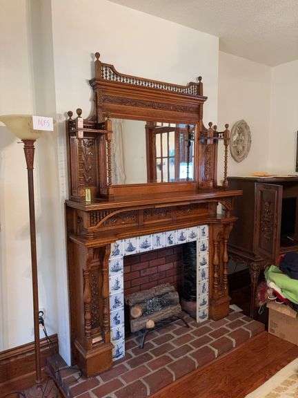 Magnificent fireplace mantle 60" wide x 88" tall. Ornately carved panels, stick and ball spindles, beveled edge mirror. A wonderful piece to reinstall in your home! This was built in as an artificial fireplace years ago and will need to be unblocked from the wall. It appears to be bolted to false bump out built to give it a real fireplace look. Mantle was from old house in Chicago.