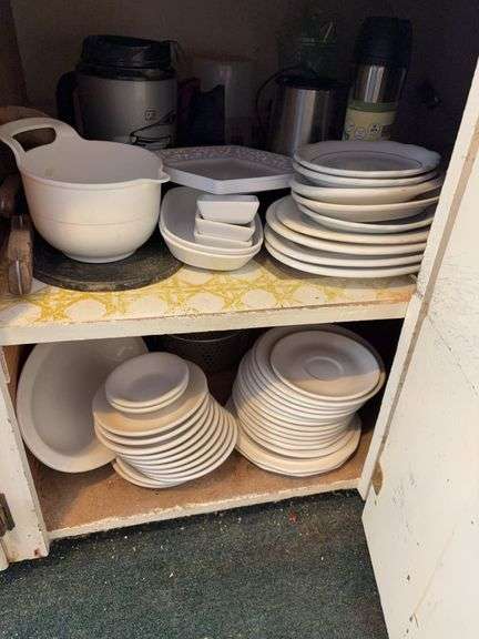 Cupboard full of white dishes image