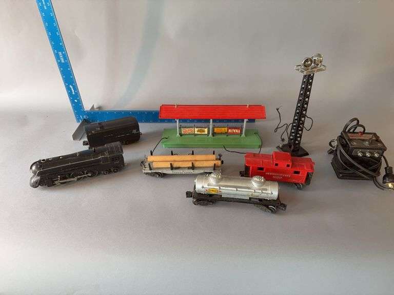 Lionel train set, prob early 40’s with smoker Comes w oval board (not shown) to put under Christmas tree. Engine 221, 2-6-4 wheel configuration, controller, depot platform, search light tower image