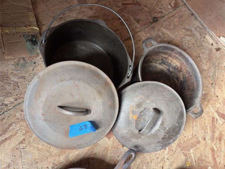 Two unmarked cast-iron Dutch ovens