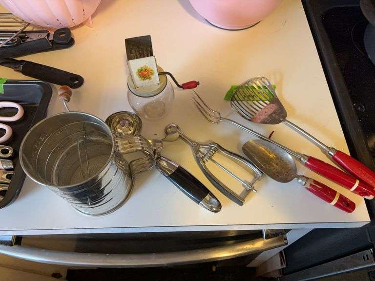 Vintage kitchen items includes sifter, chopper, scoops and a fork image