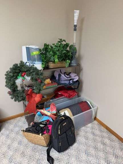 Metal shelf and contents includes gloves, Christmas wreath, comforter, cozy blanket and more image