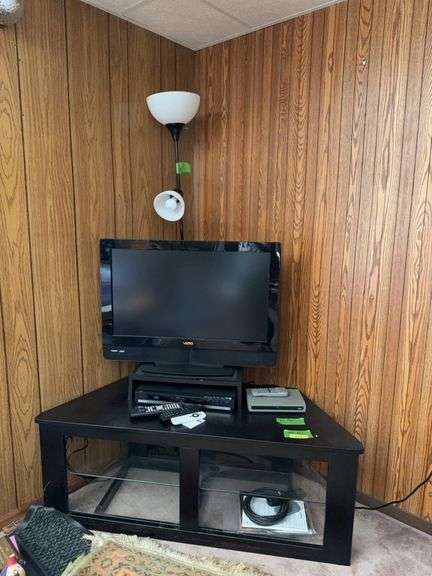 Large flat-screen tv stand w/ glass shelf, 31" Vizio HDTV, blue ray player and black floor lamp image