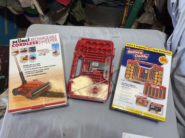 New in box cordless sweeper and two battery daddy storage systems