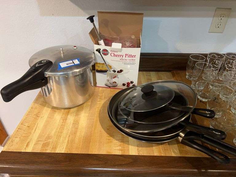 Pressure cooker, set of skillets, cherry pitter, and assorted canning supplies