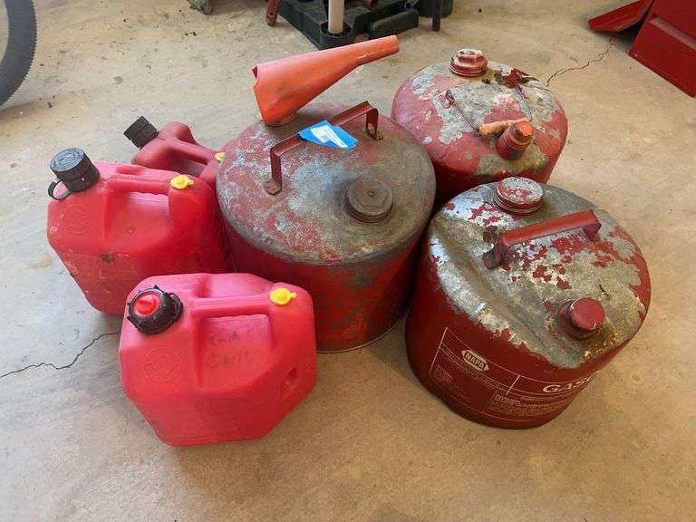 Three metal and three plastic gas cans