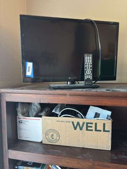 Element brand flatscreen TV and two boxes of various electronics and cords