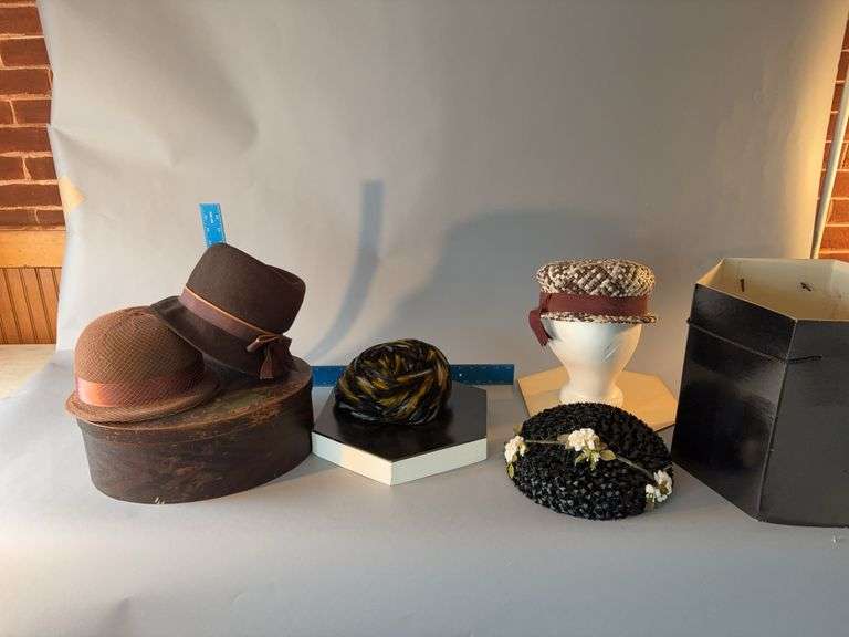 Wooden hat box and several women’s hats image