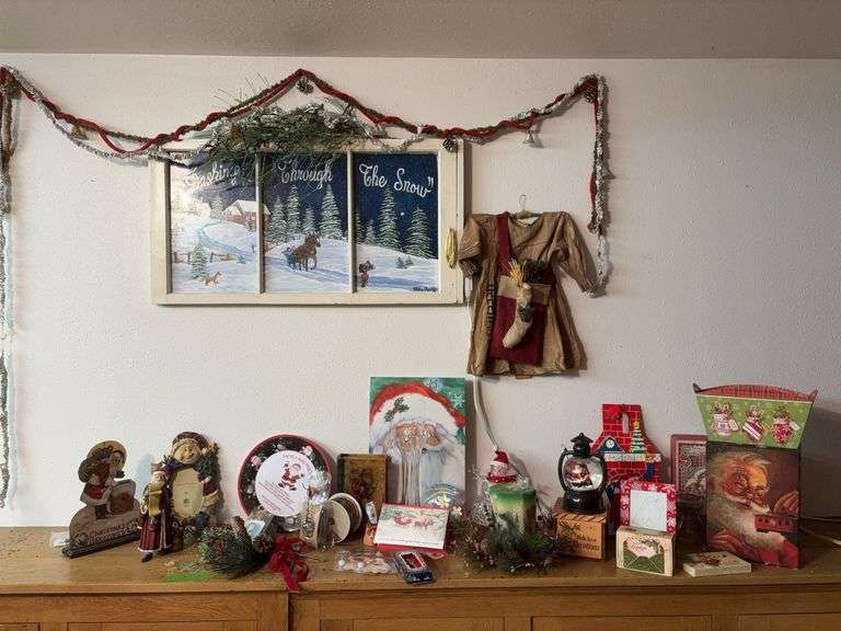 Christmas decor includes painted window, candle, Santas, picture frames,  etc image