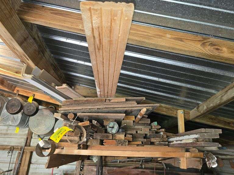 Various lumber on ceiling rack and floor