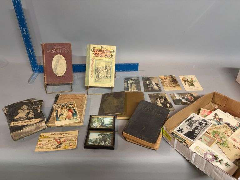 Box of vintage books and postcards image