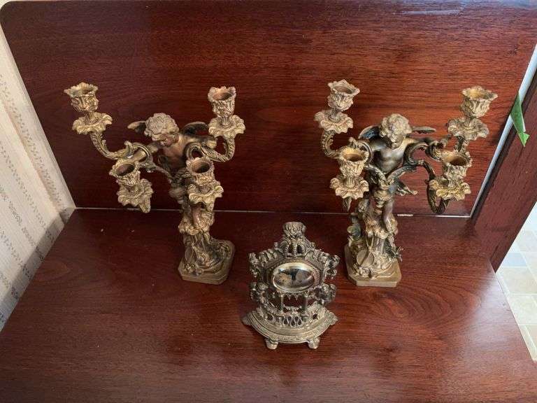 Winged cherub candlesticks and modern metal clock
