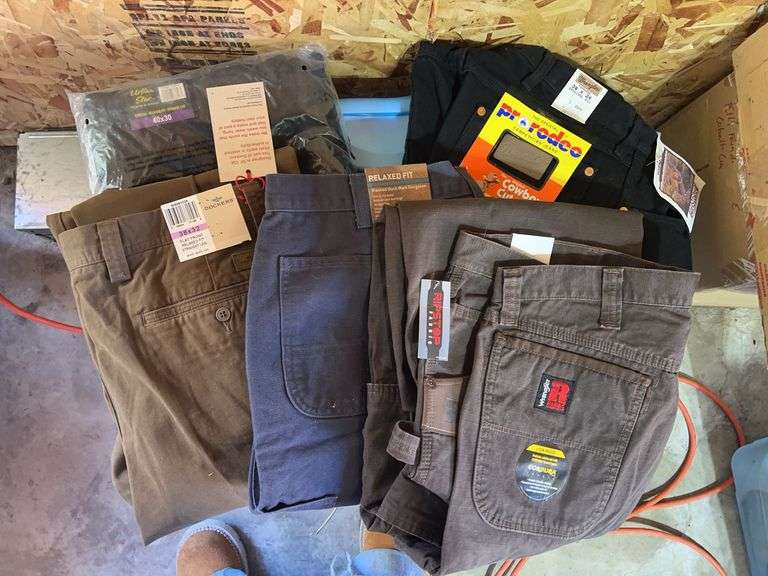 Five pairs of men’s pants new with tags includes Carhartt, Wranglers, Dockers - all size 38 waist with one size 40. 30 to 34 inch length