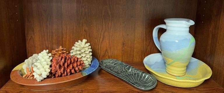 Pinecone candles, pottery pitcher, bowl and tray