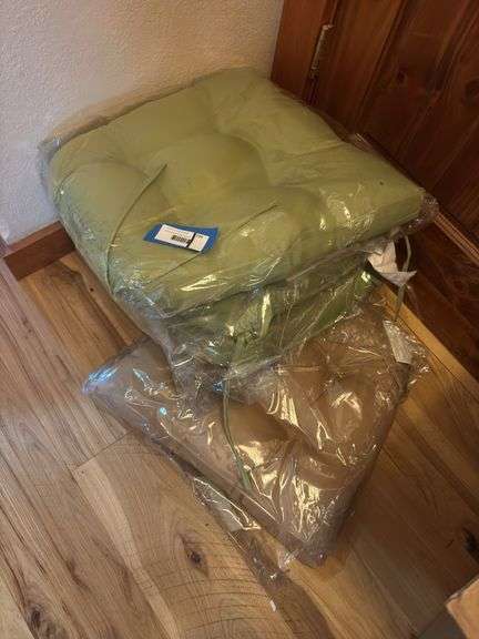 Three green and one brown chair cushions