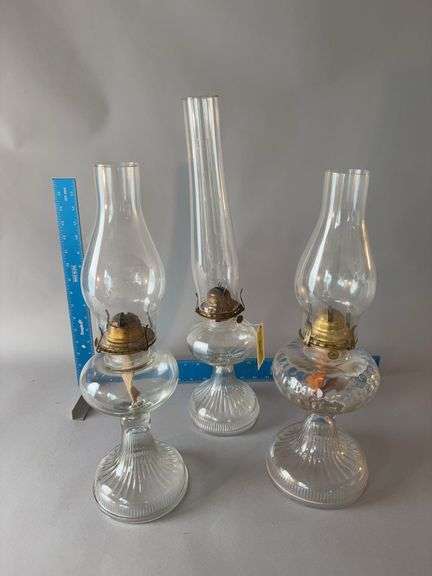 Three oil lamps , one shade cracked image