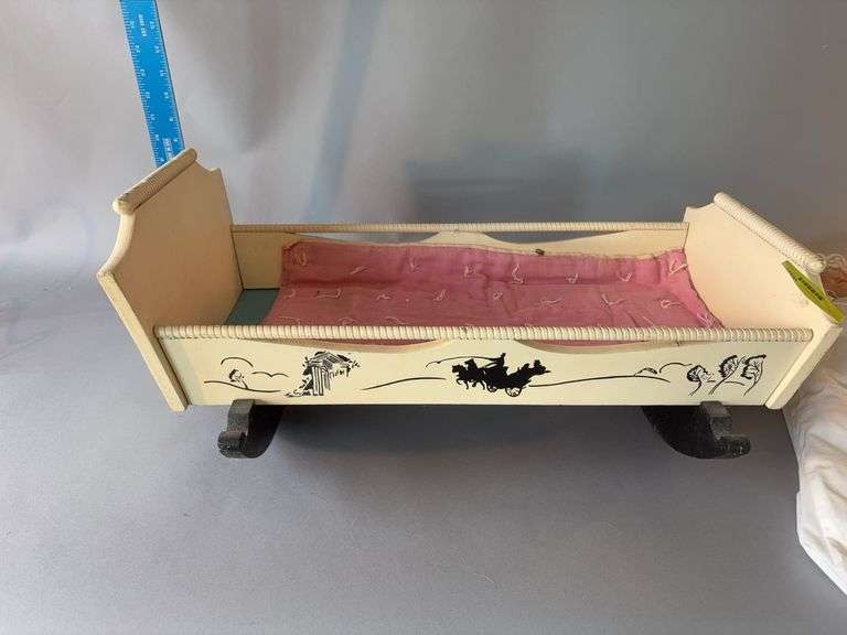 Bisque doll and doll cradle image