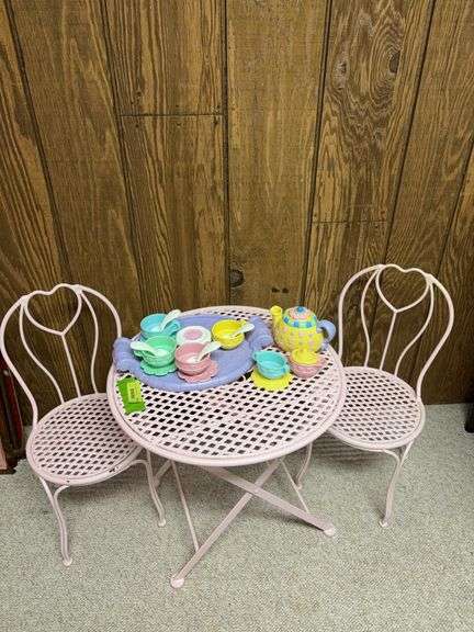 Child size pink painted metal patio style table with two chairs and tea set image
