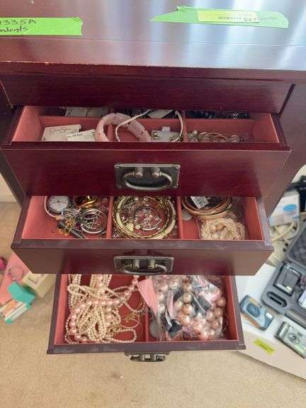 Contents of jewelry armoire includes necklaces, bracelets, earrings and more image