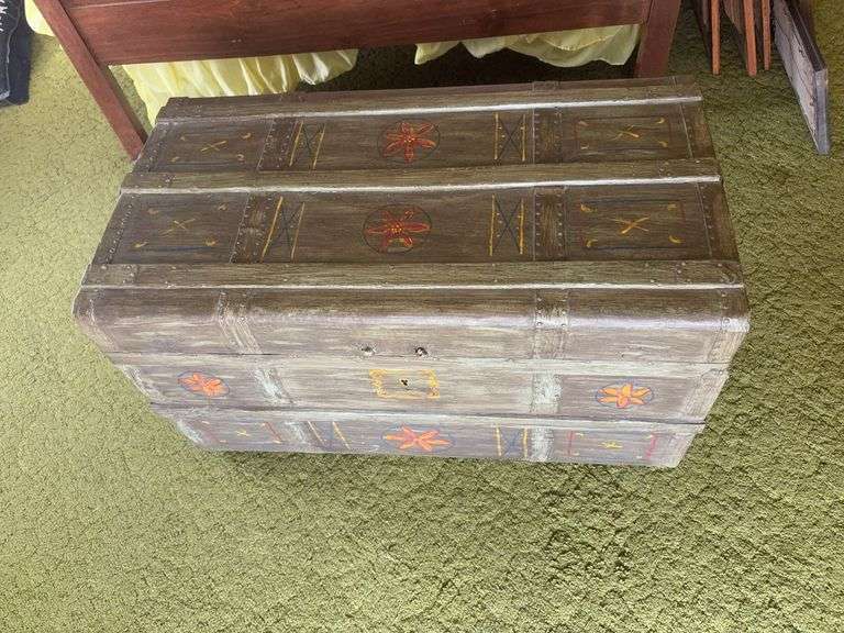 Painted trunk with metal handles on wheels  18x34x19H image