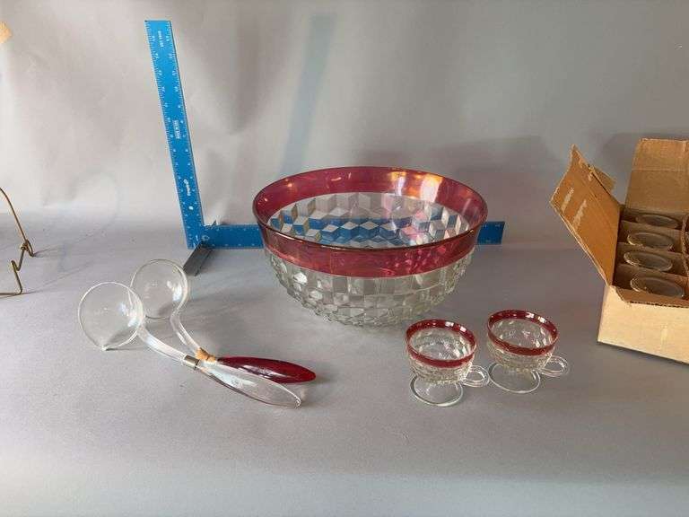Ruby flash punch bowl with 12 ruby flash cups and 2 plastic ladles Handle has been repaired on one image