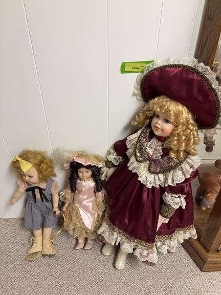Three collector dolls, one hard plastic and two bisque with cloth bodies image