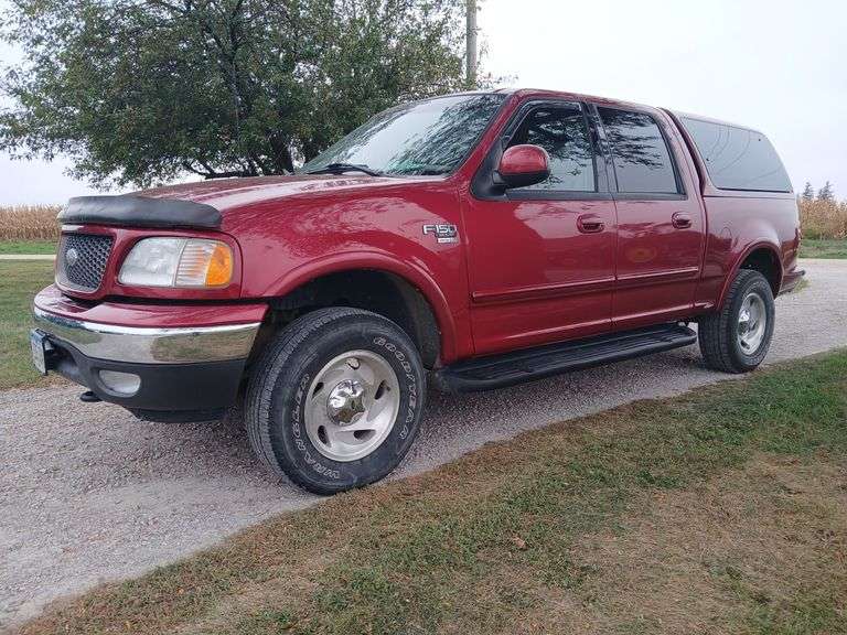 2003 Ford F-150, Crew cab, 4WD, color match Leer topper, 119K+ miles, shows no signs of rust but paint is chipped off on lower corners of box, 5.4 L engine. Exhaust manifold bolts are rusted and rattling according to mechanic, estimated $700 to repair. Front Brakes and rotors @102k, new rear tires 7-25-2024. Seller purchased with Rebuilt IA title and has been driving for several years. VIN 1FTRW08L73KD59018 *WIRE TRANSFER REQUIRED* image