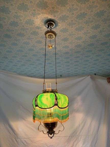 Electrified hanging lamp with brass font, green stained glass style shade, smoke bell, ceiling reel, two matching rings image