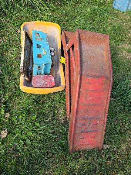 Red car ramps, old Nylint tin camper, tobacco can and kids sled