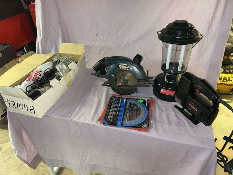 Kenroy international 12-volt halogen light fixture with with four halogen lamps 50 w, and various mounting options. Coleman fluorescent lantern uses two 6 volt lantern batteries or 12 volt power supply not included, not tested, Craftsman saber saw, Black& Decker 7-1/4-in circular saw with new blade, Craftsman tool box 17-in w x 7-1/2 in h x7 in d includes Craftsman wrenches. Royal 16 sheet crosscut shredder. image