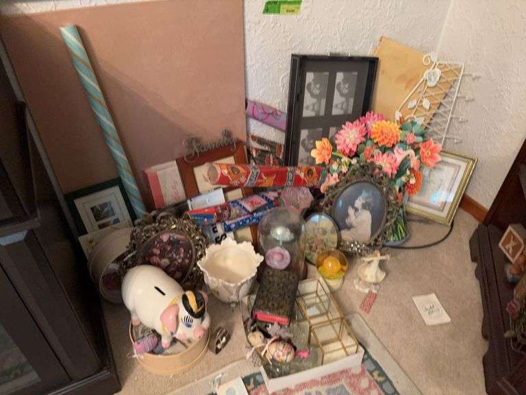 Corner of goodies includes picture frames, piggy bank, wall art, paper flower bouquet, mini shoes and more image