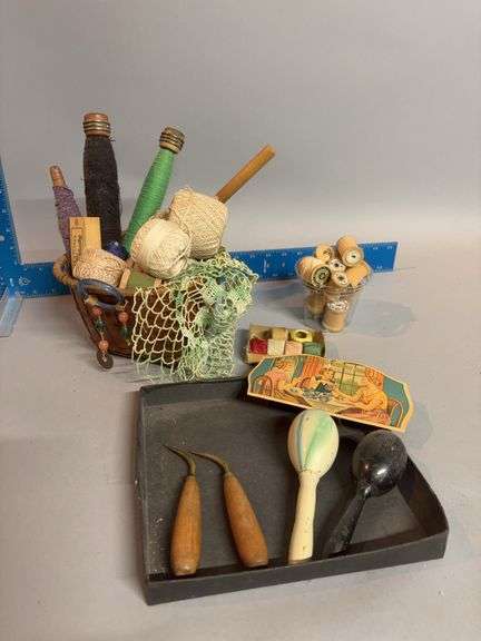 Basket of sewing notions includes thread, spools, darners, needle book image