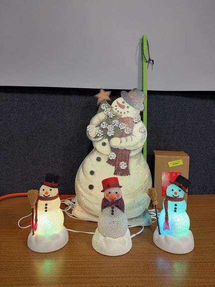 Three Avon light up snowmen and a stand up Santa image