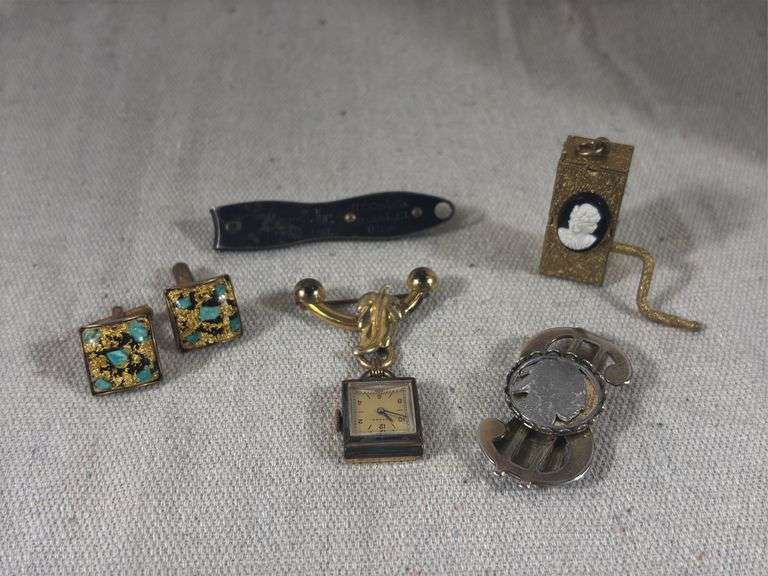 Vintage wind up silhouette music box, Indian head nickel money clip, Gotham Swiss made watch brooch, men’s cufflinks with gold? Flakes image