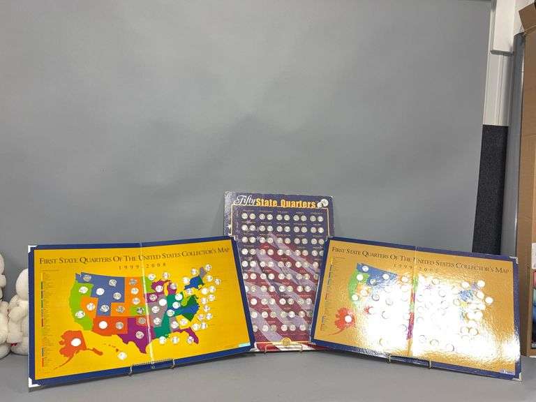 Fifty state quarters + Sacajawea dollars on collector poster and (2) First State Quarters of the US on collectors maps All complete image