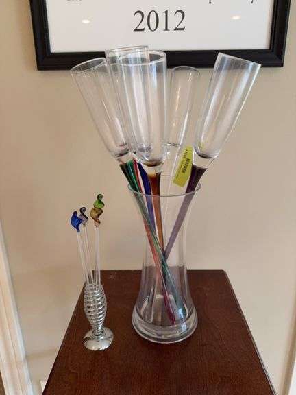 Colored glass champagne flutes and glass swizzle sticks image