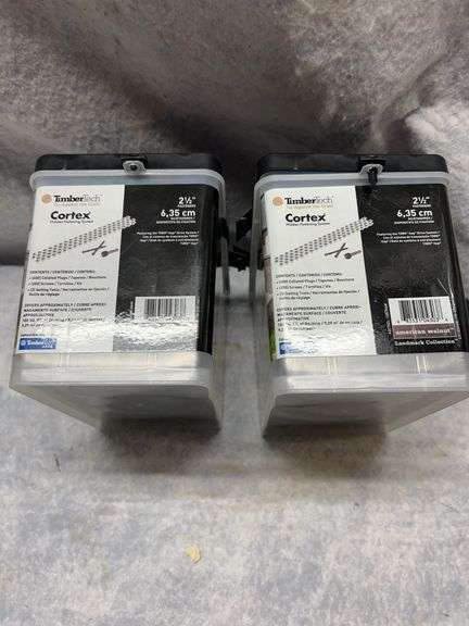Two boxes approximately 400 count Timber Tech Cortex hidden fasteners 2.5 in long American Walnut color. Two 500W work lights on tripod. image