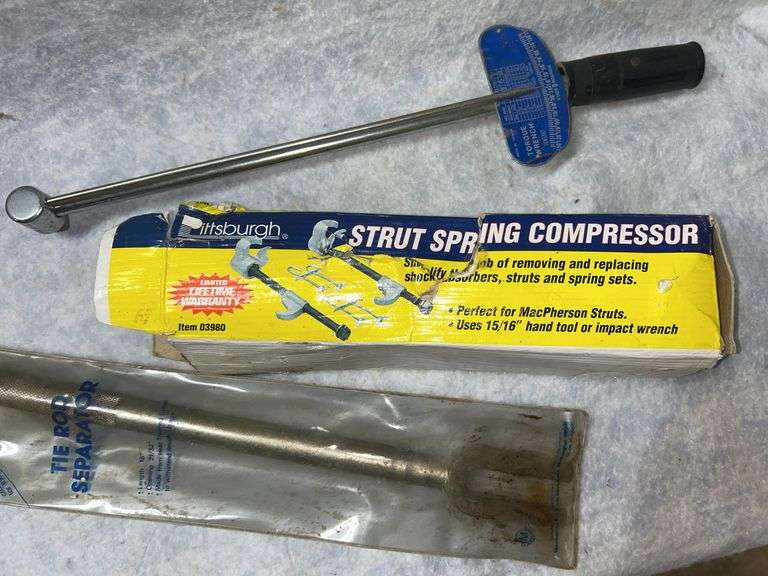 Front wheel bearing remover/installer, two warning triangle signs in case, strut spring compressor, torque wrench, Sears timing light, 2 Kurt drop hitches consisting of 2 -3/4-in drop, 1- 1/4-in sq mount, and a 1-1/4-in sq mount with 2-in ball. image
