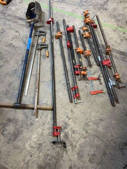 Eight half inch pipe clamps, one at 5 ft, One at 42 in, two at 36 in, one at 30 in, two at 24 in, one at 18 in, post hole digger. image