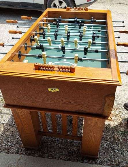 KT Sports FOOSBALL table, FULL SIZE, corner damage AS-IS (2-1-56-012 ML)  100% functional, nice table, accessories included are noted in photos. Casters are not attached, table legs are just set on them. Exterior corner water damage is old, completely dry now. There is minor puckering of the "field" in each corner (see photo). See photos for any more condition details. Table has been in storage, may need additional cleaning.  Dimensions: 56"L x 31"W (w/o rods) 35"H overall (w/o casters) (37"H overall w/casters) image