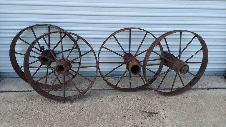 Set of (4) 27" steel wagon wheels (garden decoration, landscape wagon build). Left set(2): 27"dia, 4" tread width. Right set(2): 27"dia, 3" tread width. All are in standard antique condition, rust patina, all intact with no major damage. image