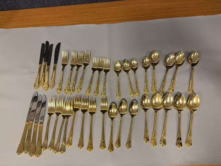 Two sets gold handled flatware for 4, short one fork image